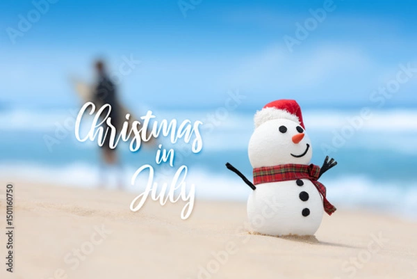 Obraz When snowmen need a break too. Beach day for a snowman. Surfer walking with surfboard in the background