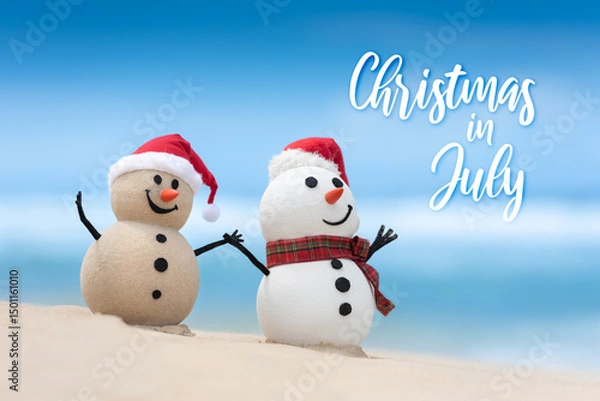 Obraz Christmas in July sale template design with a snowman and a sandy snowman on a beautiful beach, with hands held together