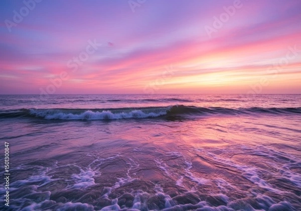 Fototapeta Photo of a Pink Sunset Over the Ocean With Waves and a Textured Water Surface