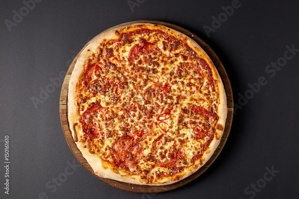 Obraz Hot pizza on a rustic wooden table.