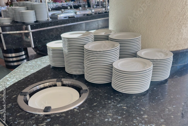 Obraz A stack of white plates in a hotel buffet restaurant.