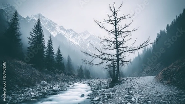 Fototapeta A tranquil mountain landscape featu a winding river, snow-capped peaks, and a solitary tree in a misty atmosphere that invites peaceful contemplation and reflection.