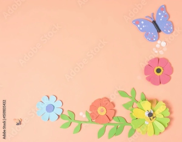 Fototapeta Pastel Peach Background with Felt Flowers Butterfly and Bee in Corner Arrangement