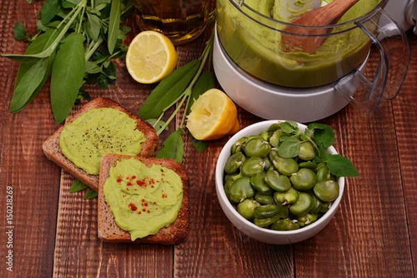 Fototapeta Toast with bean paste and boiled broad beans on wooden background.