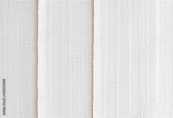 Fototapeta Close-up view of a white fabric with a grid pattern.