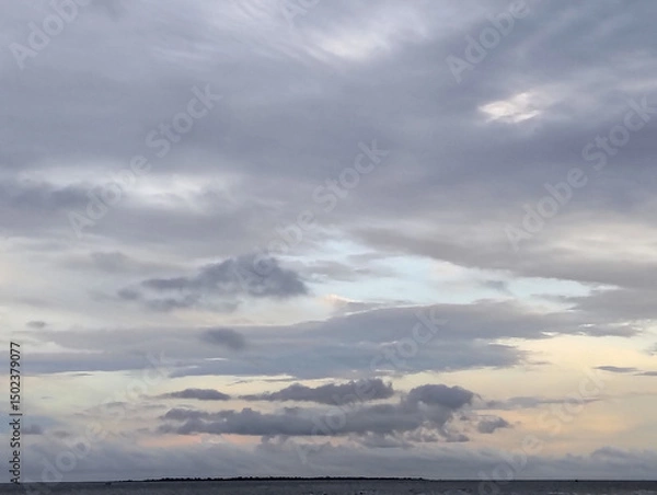 Fototapeta Cloudy sky and riverside view, The sky is cloudy and the ocean is calm