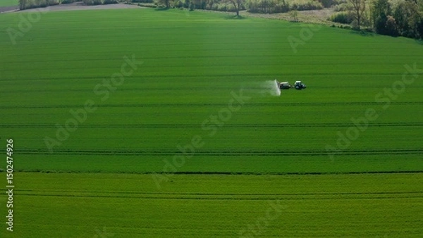 Obraz Aerial View of Tractor Spraying Green Field