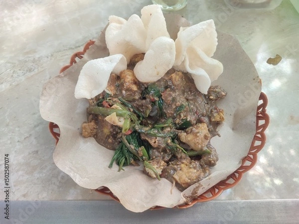Obraz Rujak Cingur is a flavorful East Javanese delicacy from Surabaya, combining cow snout, fruits, vegetables, and spicy petis sauce into a bold, unforgettable taste.