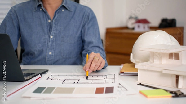 Fototapeta Adult Asian Architect Hand Design Blueprint for New House Project Asian Architect Planning with Blueprint on Desk Creating Design with Asian Architect
