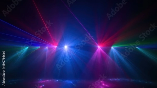 Obraz Vibrant display of colorful stage lights radiating beams of blue, red, and purple against a dark background. Central white-blue starburst effect with sharp red rays and shimmering reflections on a sur