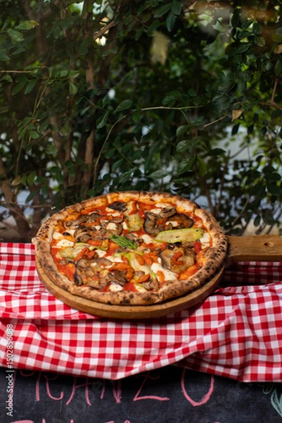 Fototapeta Wood-fired vegetable pizza topped with grilled zucchini, eggplant, and mushrooms.
