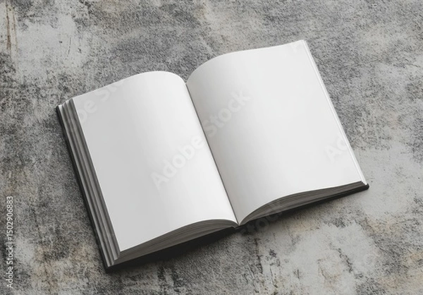 Obraz Open book, blank pages, resting on a mottled grey surface.  The pages are pristine white, and the book's cover is dark