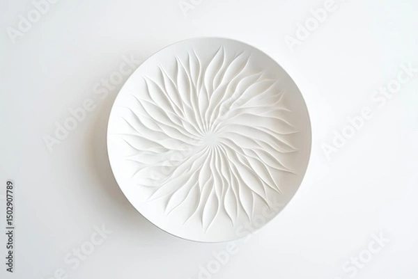 Obraz Circular white ceramic plate with intricate, radiating, leaf-like design.  Delicate, embossed patterns create a sunburst effect