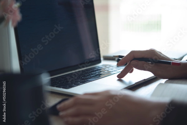 Obraz Closeup, person using laptop computer on office table. Business woman planning event schedule. Student studying online and taking note, e-learning