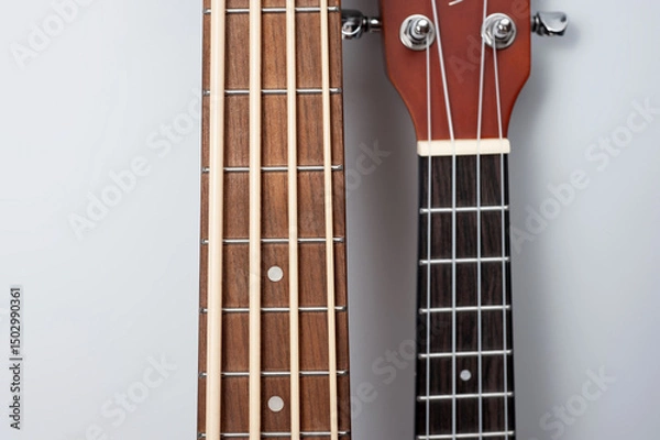 Obraz Four-string bass ukulele with wooden body and built-in tuner and pickup.