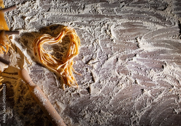 Obraz Heart shaped noodles on floured kitchen table top view cooking background with copy-space