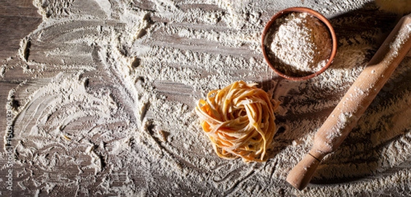 Obraz Portion of homemade noodles on floured kitchen table top view cooking background with copy-space