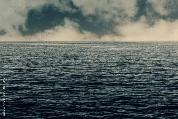 Obraz Calm weather on sea or ocean with clouds. Stormy clouds over the ocean.