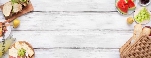 Obraz Summer picnic food double border. Top view over a white wood banner background. Picnic basket, fruit, salad, sandwiches and snacks. Copy space.