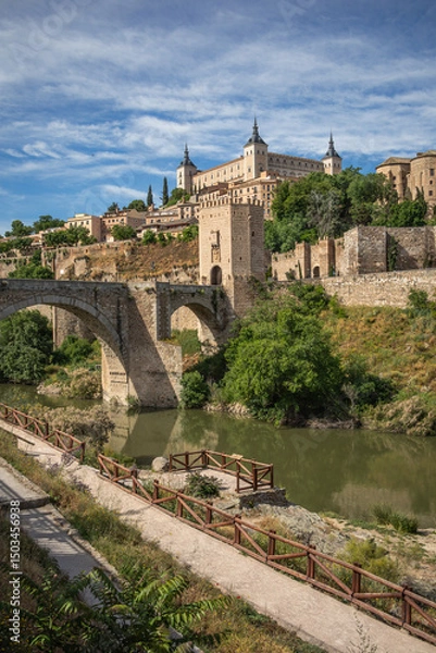 Fototapeta Vertical Scenery of Architectural Monument during Sunny Day in Toledo. Puente de Alcántara is a Roman Arch Bridge in Spain. Landmarks with Tagus River in Europe.