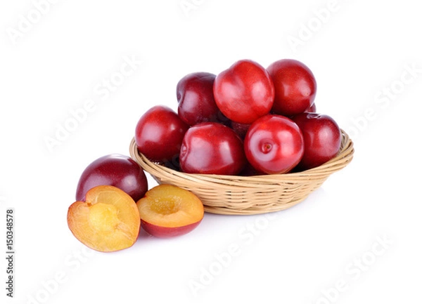 Obraz fresh gulf ruby plum in the basket and on white background