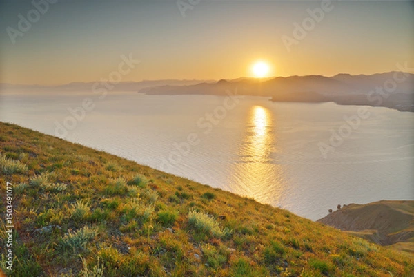 Obraz Beautiful spring nature and sea landscape of green grass on cliff during the sunset.