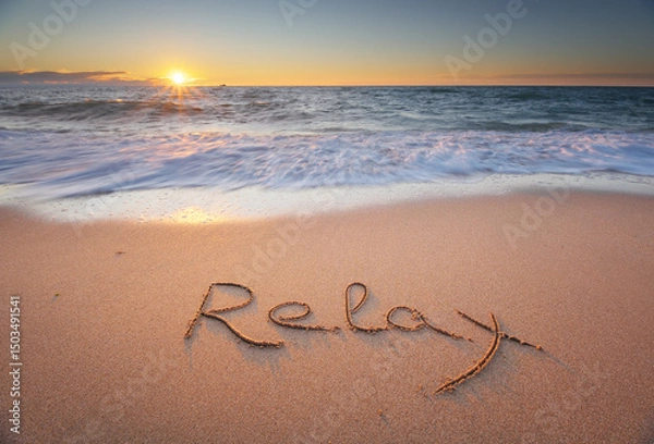 Obraz Relax word handwritten on sandy beach at sunset.