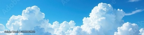 Obraz Vast, fluffy white clouds dominate a brilliant blue sky , light, serene