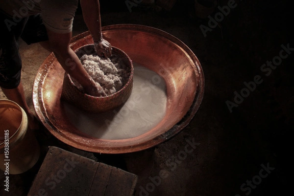 Fototapeta Traditional Coconut Milk Extraction in Indonesian Village – Pressing Fresh Coconut by Hand Using Natural Methods, Showcasing Authentic Rural Culinary Process and Southeast Asian Food Heritage