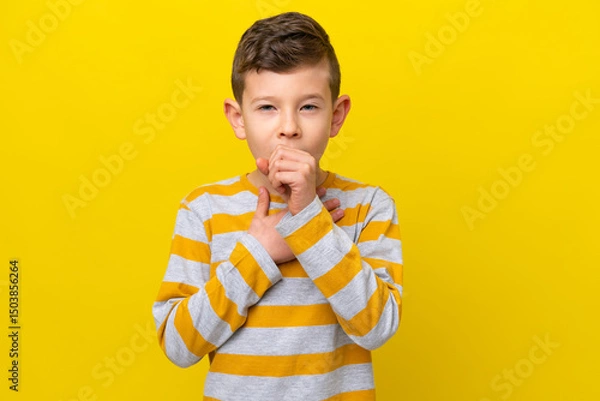 Fototapeta Little caucasian boy isolated on yellow background coughing a lot