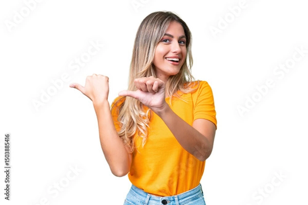 Fototapeta Young Uruguayan woman over isolated background pointing to the side to present a product