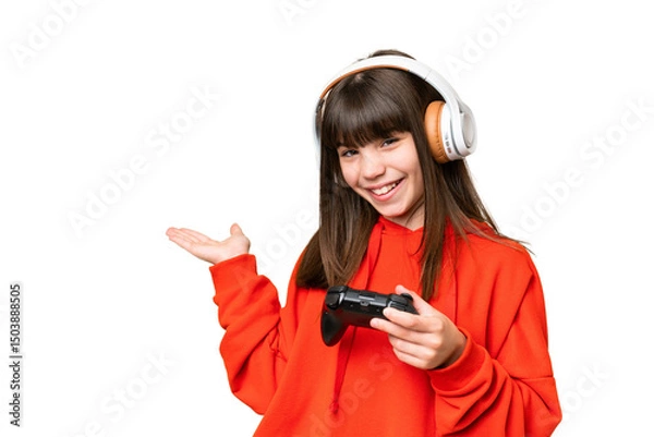Fototapeta Little caucasian girl playing with a video game controller over isolated background extending hands to the side for inviting to come