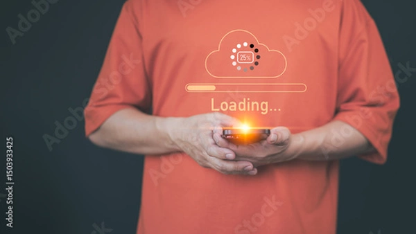Obraz Adult man holding a smartphone with a glowing orange cloud upload icon and loading progress bar, representing cloud computing, data transfer, internet of things, and digital technology.