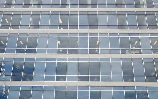 Fototapeta Generic office building exterior with sky reflected in glass windows
