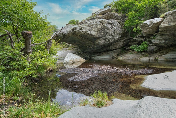 Obraz Small Waterfall in Lush Forest on Andros Island, Greece..