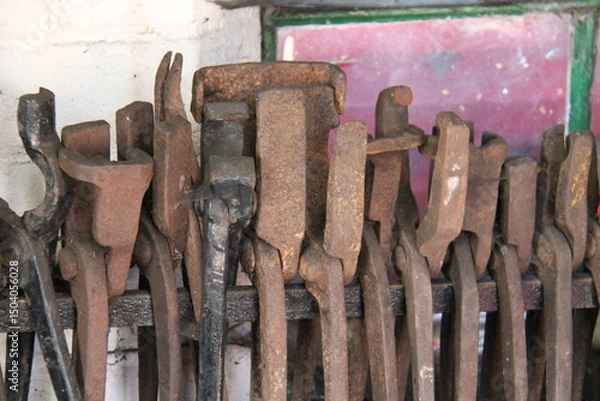 Obraz A Collection of Classic Tools in a Blacksmith Workshop.
