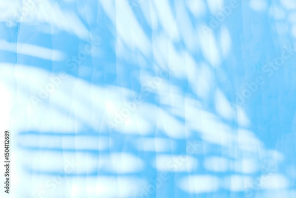 Fototapeta Blue palm leaves shadow on white paper texture background, blank white paper with leaves pattern background, blue filter effect