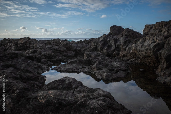 Fototapeta Reflection of a sky and rocks