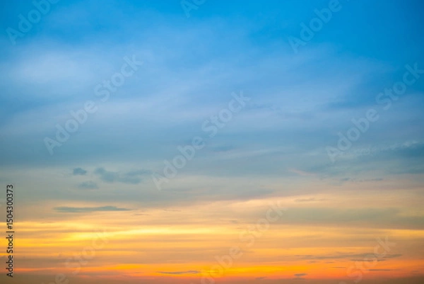 Fototapeta Sky,Beautiful sunset view, luxury soft gradient orange gold clouds and sunlight on the blue dramatic sky perfect for the background, morning, evening,Twilight, climate change,horizontal sunset photo
