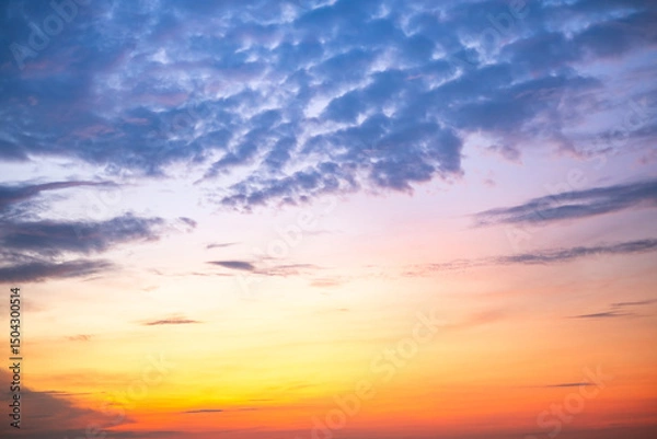 Fototapeta Sky,Beautiful sunset view, luxury soft gradient orange gold clouds and sunlight on the blue dramatic sky perfect for the background, morning, evening,Twilight, climate change,horizontal sunset photo