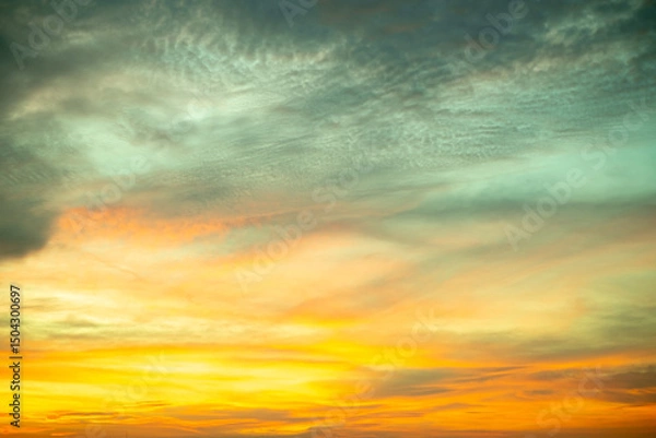 Fototapeta Sky,Beautiful sunset view, luxury soft gradient orange gold clouds and sunlight on the blue dramatic sky perfect for the background, morning, evening,Twilight, climate change,horizontal sunset photo