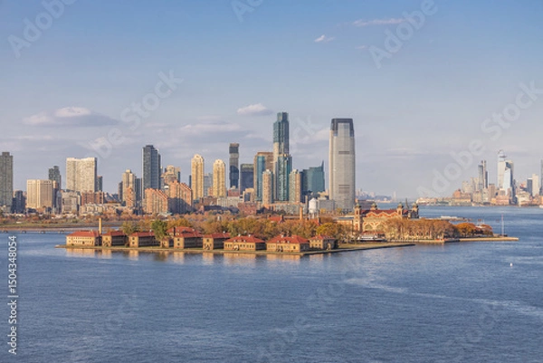 Fototapeta Panoramic view of Lower Manhattan skyline featuring One World Trade Center, seen from across the Hudson River on a clear day in New York City.