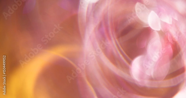 Fototapeta Swirling circle. Defocused radiance. Multicolored pink yellow lens flare on blurred bokeh light abstract background.