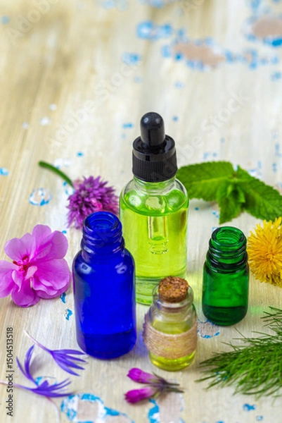 Fototapeta Essential oils and herbs on table