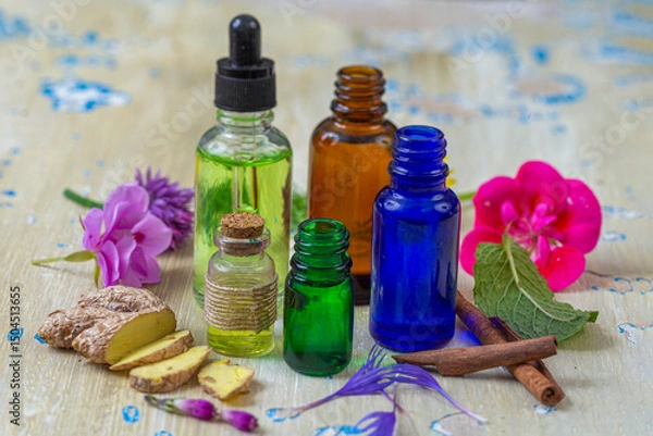 Fototapeta Essential oils and herbs arranged on a table