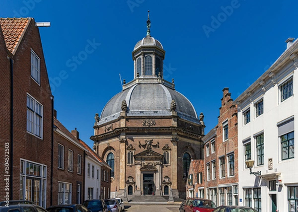 Obraz View through a historic brick street to the entrance of the East Church (Oostkerk) in Middelburg, province of Zeeland, The Netherlands