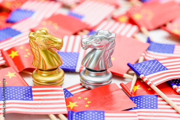 Fototapeta Golden and silver knight chess pieces represent the tactical competition between China and the US, surrounded by their respective flags, depicting the intricate trade negotiations, economic rivalries.