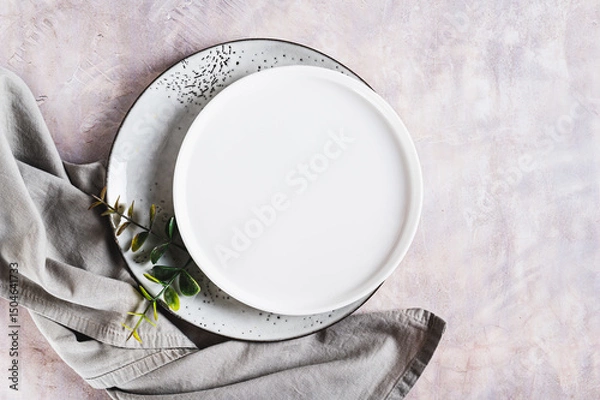 Fototapeta Pair of empty ceramic plates with napkin on gray background top view