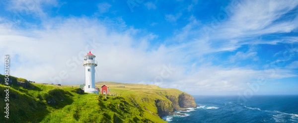 Fototapeta Akraberg Lighthouse, Suduroy Island, Faroe Islands, Denmark. Panoramic view of the rocks, field and the ocean. Scenic place for travel. Background, wallpaper, postcards.