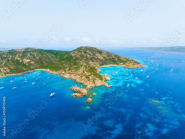 Fototapeta Island in the middle of the sea. Drone view of a yachts, boats and island. Vacationing people. North-eastern Sardinia, Maddalena Archipelago. Vacation and holidays. Summer time for sea travel.
